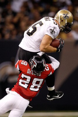 NEW ORLEANS - SEPTEMBER 26:  David Thomas #85 of the New Orleans Saints is tackled as he makes a catch over Thomas DeCoud #28 of the Atlanta Falcons at the Louisiana Superdome on September 26, 2010 in New Orleans, Louisiana.  (Photo by Chris Graythen/Gett