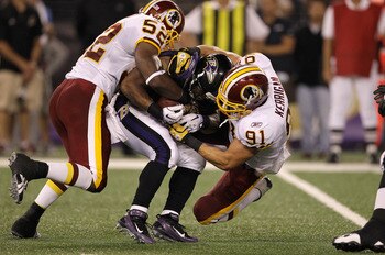 BALTIMORE, MD - AUGUST 25: Running back Ray Rice #27 of the Baltimore Ravens is tackled by Rocky McIntosh #52 and Ryan Kerrigan #91 of the Washington Redskins during a preseason game at M&T Bank Stadium on August 25, 2011 in Baltimore, Maryland.  (Photo b