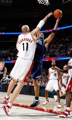 CLEVELAND - NOVEMBER 16: Carlos Boozer #5 of the Utah Jazz lays the ball up against Zydrunas Ilgauskas #11 of the Cleveland Cavaliers during the game on November 16, 2007 at Quicken Loans Arena in Cleveland, Ohio.  The Cavs won 99-94.  NOTE TO USER: User