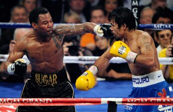 LAS VEGAS, NV - MAY 07:  Shane Mosley (L) throws a left at Manny Pacquiao in the sixth round of their WBO welterweight title fight at the MGM Grand Garden Arena May 7, 2011 in Las Vegas, Nevada. Pacquiao retained his title with a unanimous-decision victor