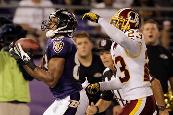 Baltimore wide receiver Lee Evans makes a catch in stride past Washington Redskins cornerback DeAngelo Hall.
