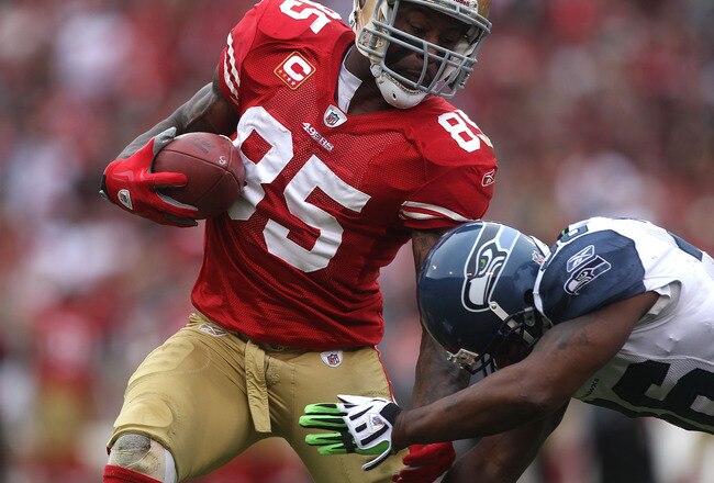 SAN FRANCISCO - DECEMBER 12:  Vernon Davis #85 of the San Francisco 49ers runs after a catch as Lawyer Milloy #36 of the Seattle Seahawks defends during an NFL game at Candlestick Park on December 12, 2010 in San Francisco, California.  (Photo by Jed Jaco