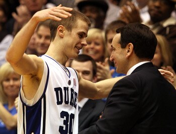 DURHAM, NC - MARCH 06:  Jon Scheyer #30 of the Duke Blue Devils goes to hug coach Mike Krzyzewski on senior night during their game against the North Carolina Tar Heels at Cameron Indoor Stadium on March 6, 2010 in Durham, North Carolina.  (Photo by Stree