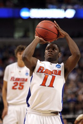 TAMPA, FL - MARCH 19:  Erving Walker #11 of the Florida Gators attempts a free throw against the UCLA Bruins during the third round of the 2011 NCAA men's basketball tournament at St. Pete Times Forum on March 19, 2011 in Tampa, Florida. Florida won 73-65