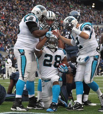 SEATTLE, WA - DECEMBER 05:  Running back Jonathan Stewart #28 of the Carolina Panthers celebrates with teammates after scoring a touchdown in the second quarter against the Seattle Seahawks at Qwest Field on December 5, 2010 in Seattle, Washington. The Se