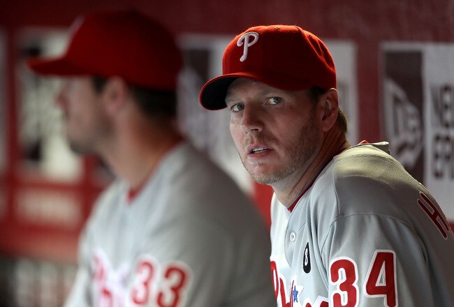 PHOENIX, AZ - APRIL 26:  Pitcher Roy Halladay #34 (R) and Cliff Lee #33 of the Philadelphia Phillies sit in the dugout during the Major League Baseball game against the Arizona Diamondbacks at Chase Field on April 26, 2011 in Phoenix, Arizona.  (Photo by