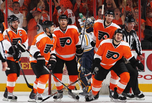 PHILADELPHIA, PA - APRIL 26:  Daniel Carcillo #13 of the Philadelphia Flyers celebrates scoring a third period goal against Jhonas Enroth #1 of the Buffalo Sabres with teammates in Game Seven of the Eastern Conference Quarterfinals during the 2011 NHL Sta