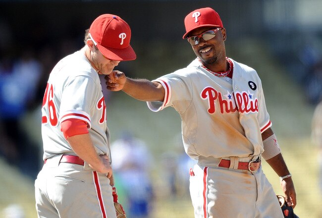 LOS ANGELES, CA - AUGUST 10:  Jimmy Rollins #11 of the Philadelphia Phillies and Chase Utley #26 joke after a 9-7 win over the Los Angeles Dodgers at Dodger Stadium on August 10, 2011 in Los Angeles, California.  (Photo by Harry How/Getty Images)
