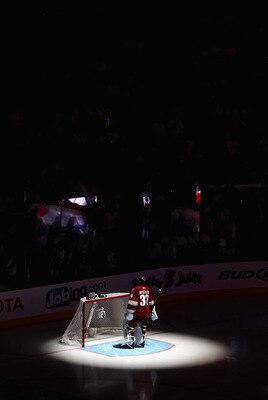 GLENDALE, AZ - APRIL 20:  Goaltender Ilya Bryzgalov #30 of the Phoenix Coyotes stands attended for the National Anthem before Game Four of the Western Conference Quarterfinals against the Detroit Red Wings during the 2011 NHL Stanley Cup Playoffs at Jobin
