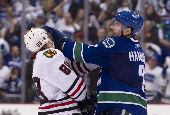 VANCOUVER, CANADA - APRIL 13: Dan Hamhuis #2 of the Vancouver Canucks gives Patrick Kane #88 of the Chicago Blackhawks a push to the face during the third period in Game One of the Western Conference Quarterfinals during the 2011 NHL Stanley Cup Playoffs