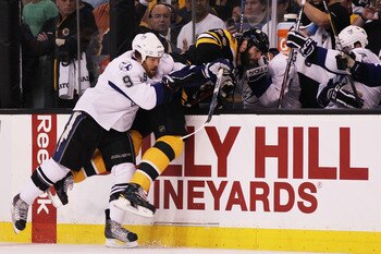 BOSTON, MA - MAY 27:  Steve Downie #9 of the Tampa Bay Lightning checks Zdeno Chara #33 of the Boston Bruins into the Tampa Bay Lightning bench in the first period of Game Seven of the Eastern Conference Finals during the 2011 NHL Stanley Cup Playoffs at