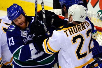 VANCOUVER, BC - JUNE 15:  Raffi Torres #13 of the Vancouver Canucks fights with Shawn Thornton #22 of the Boston Bruins during Game Seven of the 2011 NHL Stanley Cup Final at Rogers Arena on June 15, 2011 in Vancouver, British Columbia, Canada.  (Photo by