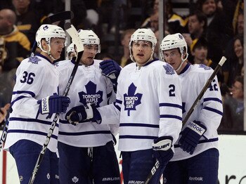 BOSTON, MA - MARCH 31:  Luke Schenn #2 of the Toronto Maple Leafs is congratulated by teammates Carl Gunnarsson #36 and Tyler Bozak #42 after Schenn scored a goal in the first period against the Boston Bruins on March 31, 2011 at the TD Garden in Boston,