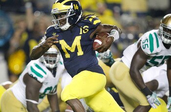 ANN ARBOR, MI - SEPTEMBER 10: Denard Robinson #16 of the Michigan Wolverines looks for yards on a fourth quarter run while playing the Notre Dame Fighting Irish at Michigan Stadium on September 10, 2010 in Ann Arbor, Michigan. Michigan won the game 35-31.