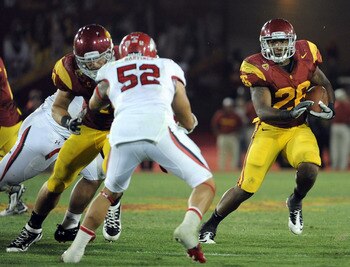 LOS ANGELES, CA - SEPTEMBER 10:  Marc Tyler #26 of the USC Trojans looks for a block on Matt Martinez #52 of the Utah Utes during the fourth quarter at Los Angeles Memorial Coliseum on September 10, 2011 in Los Angeles, California.  (Photo by Harry How/Ge