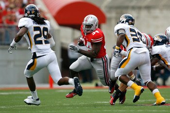 COLUMBUS, OH - SEPTEMBER 10:  Carlos Hyde #34 of the Ohio State Buckeyes runs the ball up field against the Toledo defense during the first half on September 10, 2011 at Ohio Stadium in Columbus, Ohio. Ohio State defeated Toledo 27-22. (Photo by Kirk Irwi