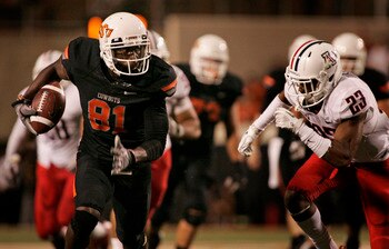 STILLWATER, OK - SEPTEMBER 8:  Wide receiver Justin Blackmon #81 of the Oklahoma State Cowboys slips past safety Mark Watley #23 of the Arizona Wildcats during the second half on September 8, 2011 at Boone Pickens Stadium in Stillwater, Oklahoma.  Oklahom