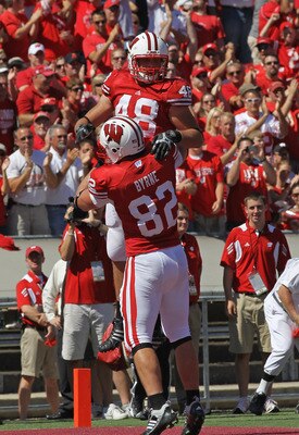 MADISON, WI - SEPTEMBER 10: Jacob Pedersen #48 of the Wisconsin Badgers is lifted by teammate Jake Byrne #82 after scoring a touchdown against the Oregon State Beavers at Camp Randall Stadium on September 10, 2011 in Madison Wisconsin. Wisconsin defeated