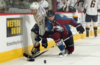 DENVER, CO - MARCH 31:  Patric Hornqvist #27 of the Nashville Predators and Philippe Dupuis #11 of the Colorado Avalanche battle for control of the puck at the Pepsi Center on March 31, 2011 in Denver, Colorado.  (Photo by Doug Pensinger/Getty Images)