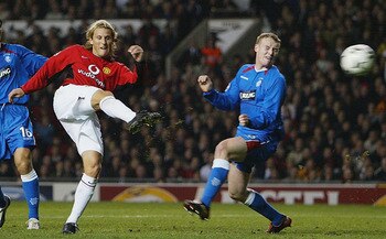 MANCHESTER, ENGLAND - NOVEMBER 4:  Diego Forlan of Manchester United makes an attempt at an early goal during the UEFA Champions League match between Manchester United and Rangers at Old Trafford on November 4, 2003 in Manchester, England. (Photo by Laure