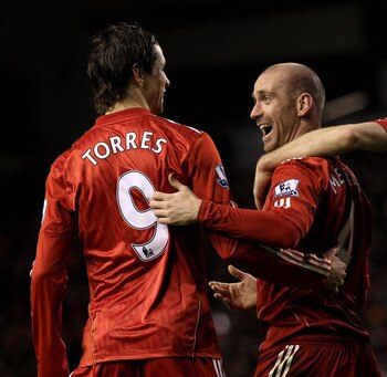 LIVERPOOL, ENGLAND - JANUARY 26:  Raul Meireles of Liverpool celebrates with team mates Fernando Torres and Steven Gerrard after John Pantsil of Fulham scored an own goal during the Barclays Premier League match between Liverpool and Fulham at Anfield on