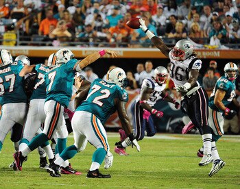 MIAMI - OCTOBER 4: Chad Henne #7 of the Miami Dolphins has his pass batted down by Jermaine Cunningham #96 of the New England Patriots at Sun Life Field on October 4, 2010 in Miami, Florida. (Photo by Scott Cunningham/Getty Images)