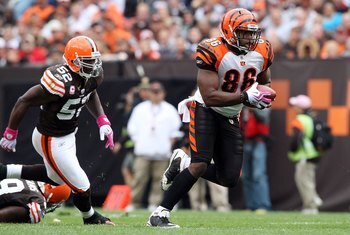 CLEVELAND - OCTOBER 04:  Daniel Coats #86 of the Cincinnati Bengals runs the ball against D'Qwell Jackson #52 of the Cleveland Browns during their game at Cleveland Browns Stadium on October 4, 2009 in Cleveland, Ohio. The Bengals defeated the Browns 23-2