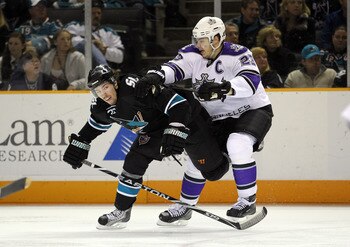 SAN JOSE, CA - APRIL 23:  Dustin Brown #23 of the Los Angeles Kings hits Logan Couture #39 of the San Jose Sharks in game five of the Western Conference Quarterfinals during the 2011 NHL Stanley Cup Playoffs at HP Pavilion on April 23, 2011 in San Jose, C