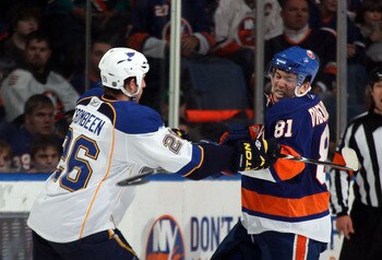 UNIONDALE, NY - MARCH 05:  B.J. Crombeen #26 of the St. Louis Blues hits Justin DiBenedetto #81 of the New York Islanders at the Nassau Coliseum on March 5, 2011 in Uniondale, New York.  (Photo by Bruce Bennett/Getty Images)
