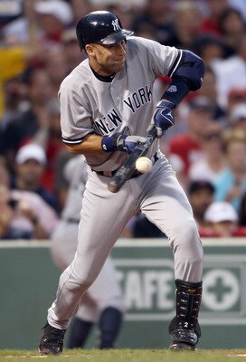 BOSTON, MA - AUGUST 31:  Derek Jeter #2 of the New York Yankees hits a SAC bunt in the first inning against the Boston Red Sox on August 31, 2011 at Fenway Park in Boston, Massachusetts.  (Photo by Elsa/Getty Images)