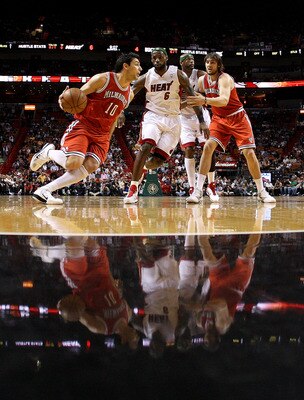 MIAMI, FL - APRIL 06:  Carlos Delfino #10 of the Milwaukee Bucks dribbles around LeBron James #6  of the Miami Heat during a game at American Airlines Arena on April 6, 2011 in Miami, Florida. NOTE TO USER: User expressly acknowledges and agrees that, by