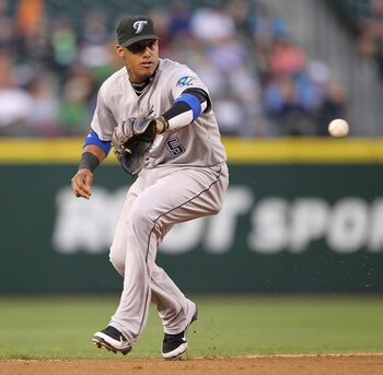 SEATTLE - AUGUST 15:  Shortstop Yunel Escobar #5 of the Toronto Blue Jays fields a bouncing ball by Casper Wells of the Seattle Mariners at Safeco Field on August 15, 2011 in Seattle, Washington. (Photo by Otto Greule Jr/Getty Images)