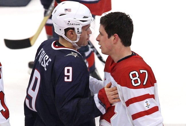 VANCOUVER, BC - FEBRUARY 28:  Zach Parise #9 of USA and Sidney Crosby #87 of Canada pat one another after shaking hands after the ice hockey men's gold medal game between USA and Canada on day 17 of the Vancouver 2010 Winter Olympics at Canada Hockey Plac