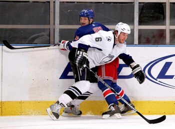 NEW YORK, NY - DECEMBER 23:  Sean Avery #16 of the New York Rangers is checked by Ryan Malone #6 of the Tampa Bay Lightning during the first period of an NHL hockey game at Madison Square Garden on December 23, 2010 in New York City.  (Photo by Paul Beres
