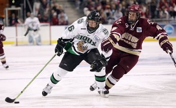 MILWAUKEE - APRIL 06:  Ryan Duncan #16 of the North Dakota Fighting Sioux moves the puck against Mike Brennan #4 of the Boston College Eagles during the NCAA Frozen Four on April 6, 2006 at the Bradley Center in Milwaukee, Wisconsin. Boston College defeat