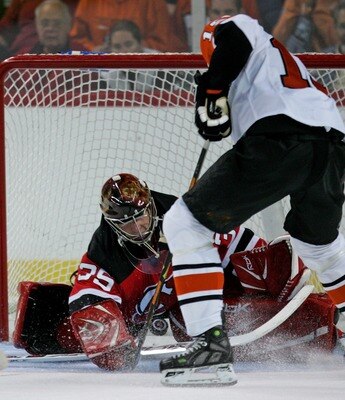 TRENTON, NJ - SEPTEMBER 17: Joffrey Lupul #15 of the Philadelphia Flyers is poke checked by Jordan Parise #35 of the New Jersey Devils on September 17, 2007 at the Sovereign Bank Arena in Trenton, New Jersey. The Flyers defeated the Devils 3-2. (Photo by