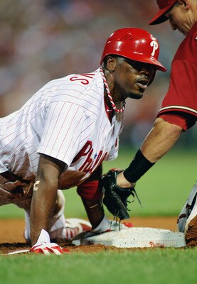 PHILADELPHIA , PA - AUGUST 17:  Jimmy Rollins #11 of the Philadelphia Phillies slides in head first on a double steal against Cody Ransom #1 of the Arizona Diamondbacks at Citizens Bank Park on August 17, 2011 in Philadelphia, Pennsylvania.  (Photo by Len