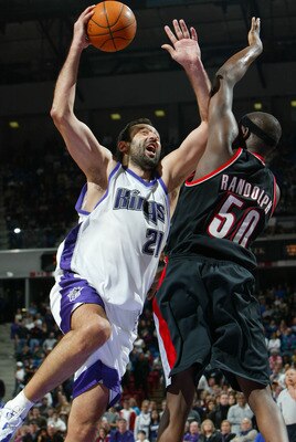 SACRAMENTO, CA -  JANUARY 20:   Vlade Divac #21 of the Sacramento Kings shoots over Zach Randolph #50 of the Portland Trail Blazers during an NBA game on January 20, 2004 at Arco Arena in Sacramento, California.  NOTE TO USER: User expressly acknowledges