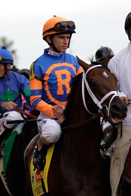 LOUISVILLE, KY - MAY 07:  Jockey Ramon A. Dominguez, riding Stay Thirsty #4, is escourted onto the track by an outrider for the running of the 137th Kentucky Derby at Churchill Downs on May 7, 2011 in Louisville, Kentucky.  (Photo by Rob Carr/Getty Images