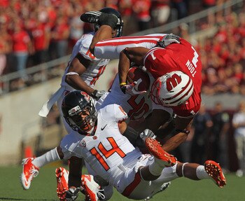 MADISON, WI - SEPTEMBER 10: Nick Toon #1 of the Wisconsin Badgers is upended by Jordan Poyer #14 and Michael Doctor #40 of the Oregon State Beavers at Camp Randall Stadium on September 10, 2011 in Madison Wisconsin. (Photo by Jonathan Daniel/Getty Images)