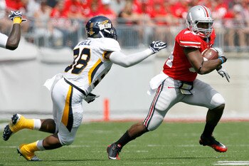 COLUMBUS, OH - SEPTEMBER 10:  Carlos Hyde #34 of the Ohio State Buckeyes is pursued by Robert Bell #38 of the Toledo Rockets on September 10, 2011 at Ohio Stadium in Columbus, Ohio. Ohio State defeated Toledo 27-22. (Photo by Kirk Irwin/Getty Images)