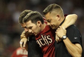 PHOENIX, AZ - JULY 20:  Stephen Drew #6 of the Arizona Diamondbacks is helped off the field after he was injured attempting to score against the Milwaukee Brewers during the fifth inning of the Major League Baseball game at Chase Field on July 20, 2011 in