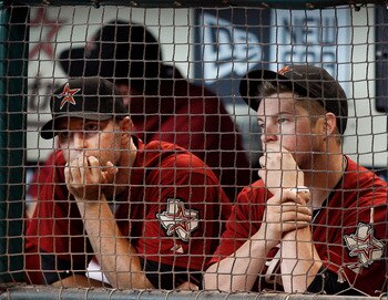 HOUSTON - SEPTEMBER 04:  PItchers J.A. Happ, left, and Bud Norris of the Houston Astros looks on from the dugout during a baseball game against the Milwaukee Brewers at Minute Maid Park on September 4, 2011 in Houston, Texas.  (Photo by Bob Levey/Getty Im