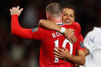 MANCHESTER, ENGLAND - AUGUST 22:  Wayne Rooney of Manchester United celebrates scoring his side's third goal with team mate Javier Hernandez during the Barclays Premier League match between Manchester United and Tottenham Hotspur at Old Trafford on August