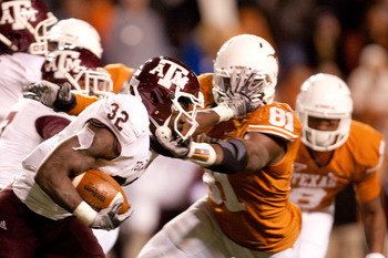 AUSTIN, TX - NOVEMBER 25:  Running back Cyrus Gray #32 of Texas A&M holds off University of Texas defensive end Sam Acho #81 during the second half at Darrell K. Royal-Texas Memorial Stadium on November 25, 2010 in Austin, Texas. (Photo by Darren Carroll/