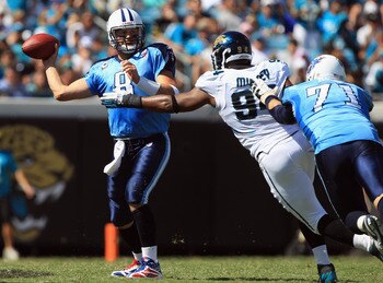JACKSONVILLE, FL - SEPTEMBER 11:  Matt Hasselbeck #8 of the Tennessee Titans tries to get away from Jeremy Mincey #94 of the Jacksonville Jaguars during their season opener at EverBank Field on September 11, 2011 in Jacksonville, Florida.  (Photo by Stree