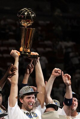 MIAMI, FL - JUNE 12:  Dirk Nowitzki #41 of the Dallas Mavericks holds up the Larry O'Brien Championship trophy after the Mavericks won 105-95 against the Miami Heat in Game Six of the 2011 NBA Finals at American Airlines Arena on June 12, 2011 in Miami, F