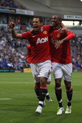 BOLTON, ENGLAND - SEPTEMBER 10:  Javier Hernandez (L) of Manchester United celebrates scoring the fourth goal with Ashley Young (R)  during the Barclays Premier League at the Reebok Stadium on September 10, 2011 in Bolton, England.  (Photo by Michael Stee
