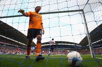 BOLTON, ENGLAND - SEPTEMBER 10:  Jussi Jaaskelainen of  Bolton Wanderers retrieves the ball from the net after Wayne Rooney had scored the third goal for Manchester United during the Barclays Premier League at the Reebok Stadium on September 10, 2011 in B