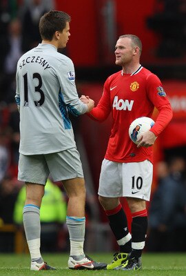 MANCHESTER, ENGLAND - AUGUST 28:  Wayne Rooney of Manchester United carries the match ball as he shakes hands with Wojciech Szczesny of Arsenal after the Barclays Premier League match between Manchester United and Arsenal at Old Trafford on August 28, 201